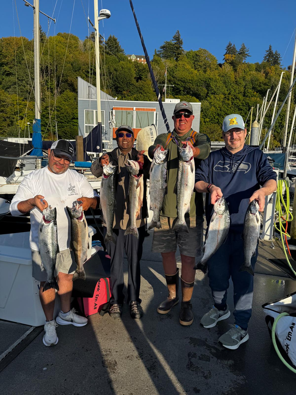 Snow Goose Capital Partners fishing tournament guests with their salmon catch
