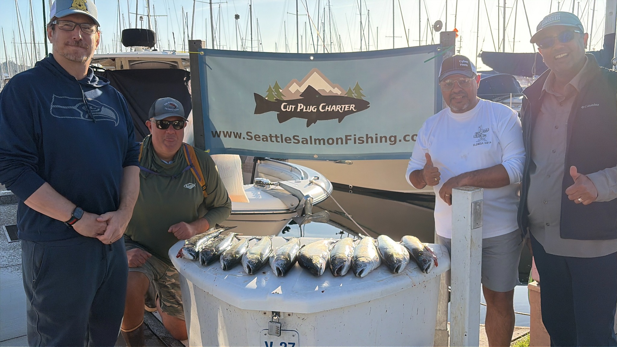 Snow Goose Capital Partners fishing tournament guests at Shilshole Marina with the day’s salmon catch
